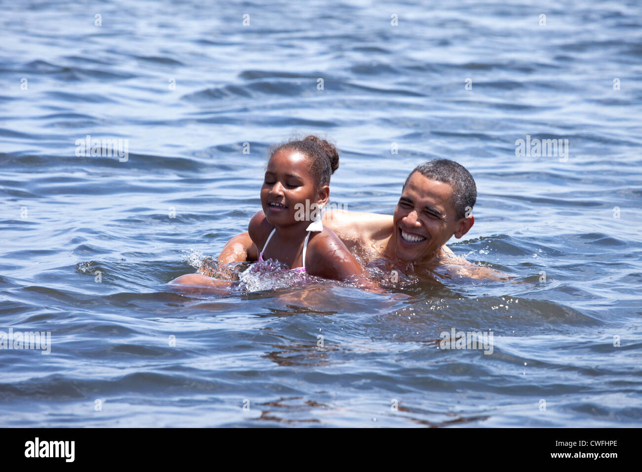 President Barack Obama and daughter, Sasha, swim at Alligator Point in Panama City Beach, Fla., August 14, 2010. The President t Stock Photo