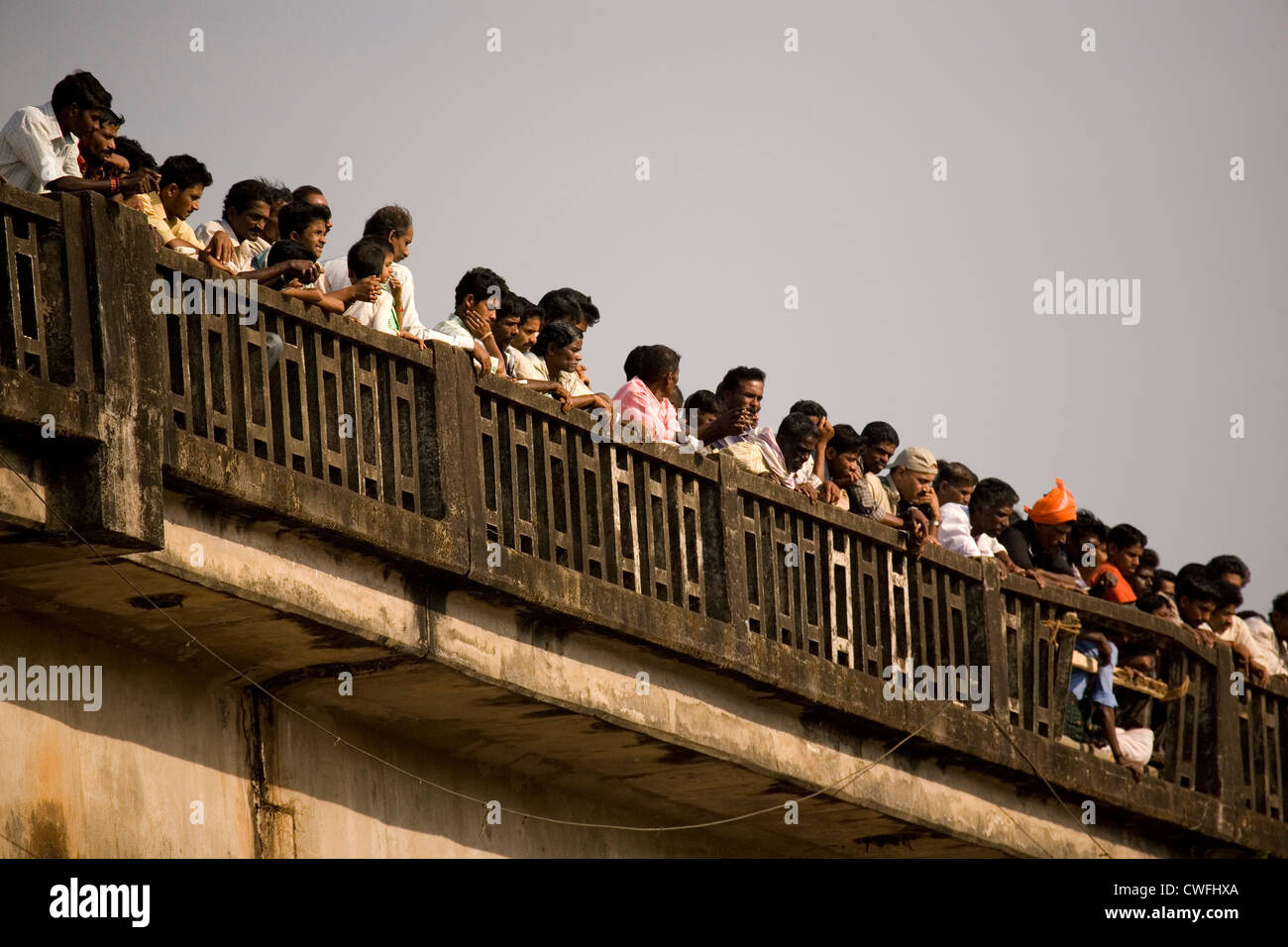 People stand on a bridge to watch Kambala racing in the Dakshina Kannada district of Karnataka, India. Stock Photo