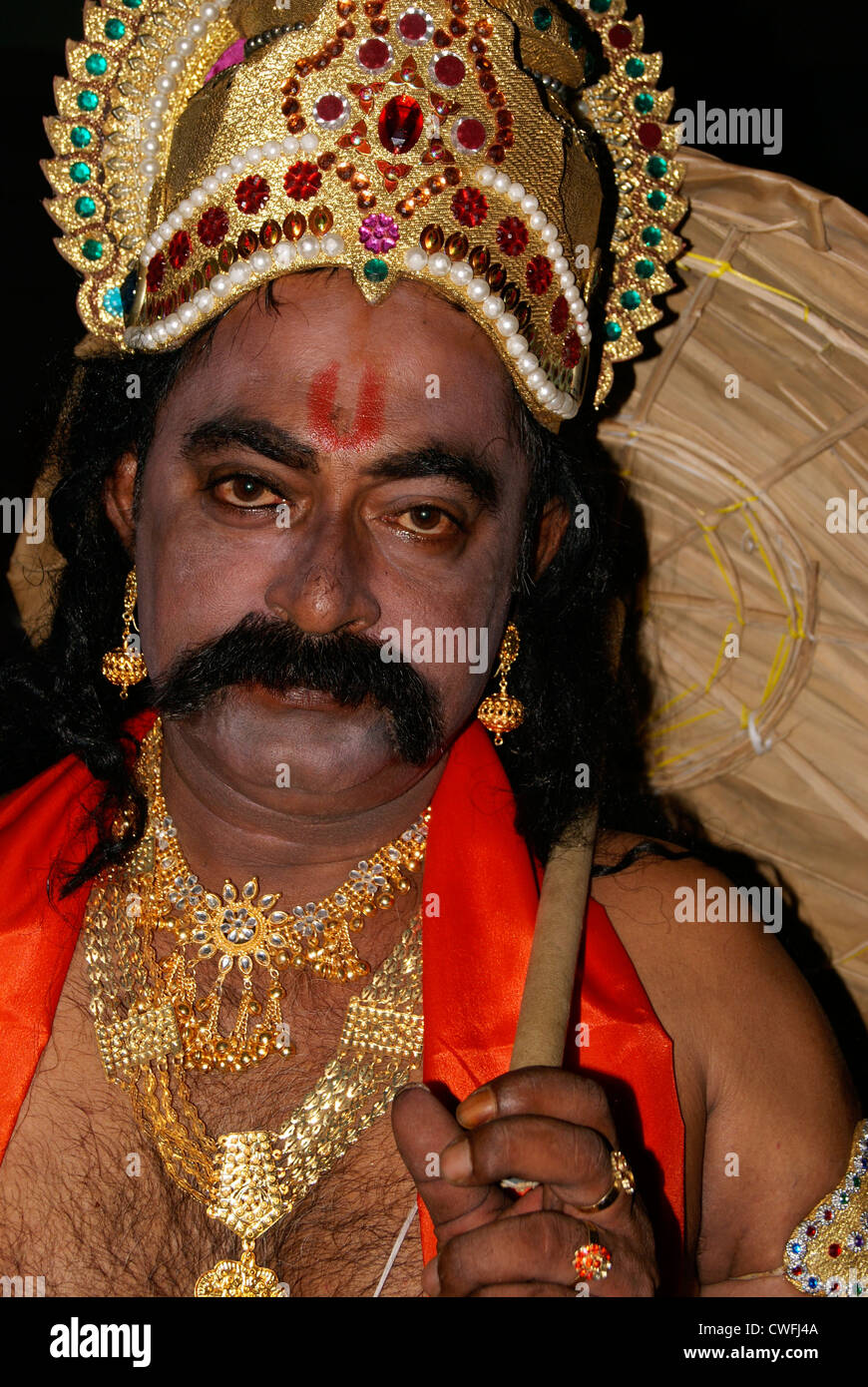 Maveli or King Mahabali Model Dressing with ornaments and Traditional Style Umbrella wearing Man for Onam Festival in Kerala Stock Photo