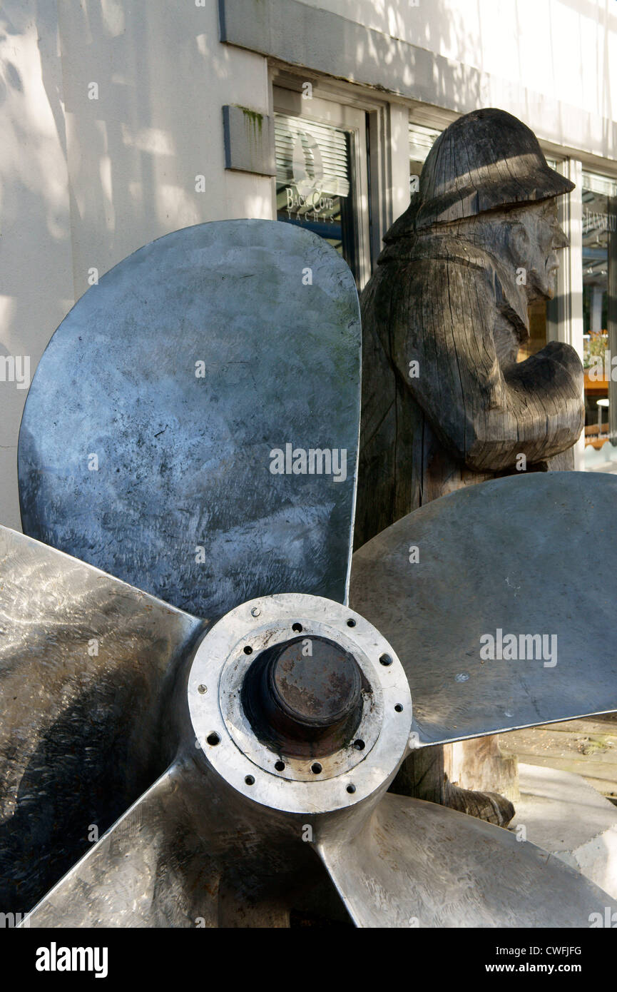 Closeup of a ship's propeller and carving of old sea captain