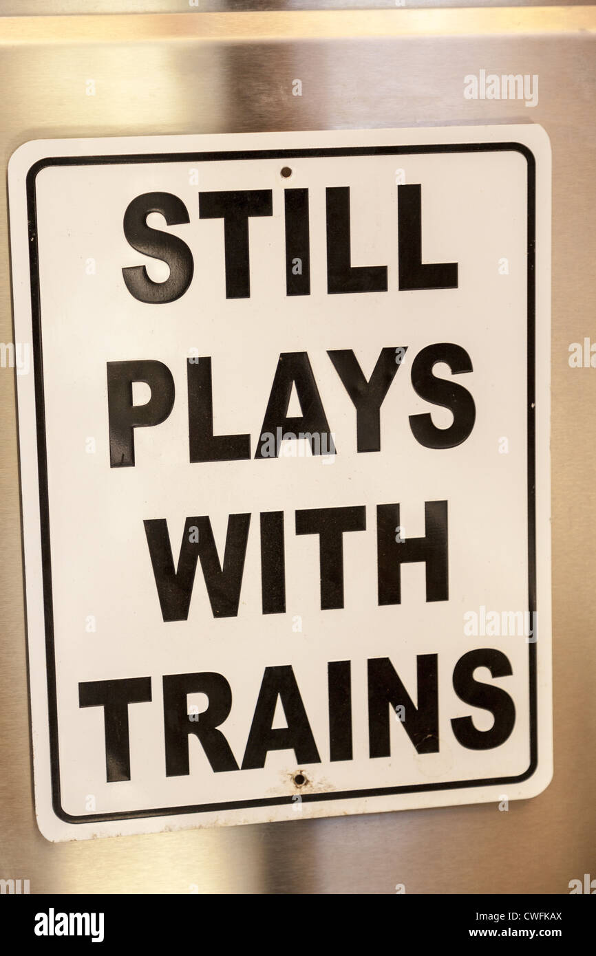Sign 'Still plays with trains' Stock Photo