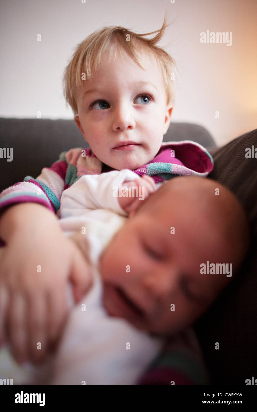 Child holding baby Stock Photo Alamy