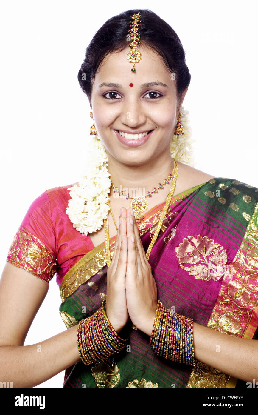 Elegant brunette south asian indian girl in saree standing under arch and  show namaste hands sign Stock Photo - Alamy