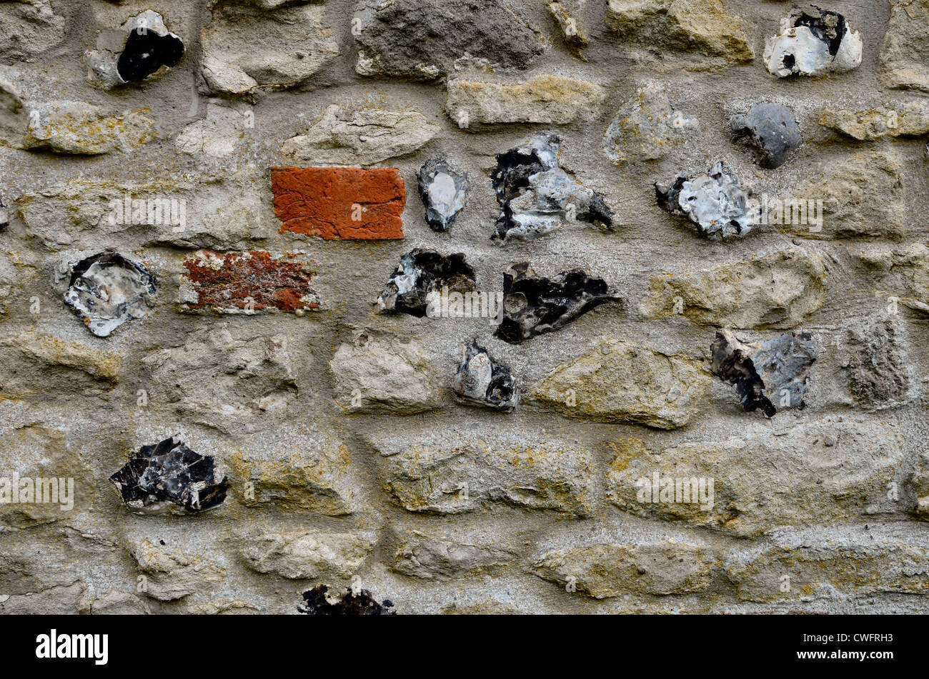Denial of access, computer security concept. Stone building wall / detail of weathered stonework with flint inlay - Wiltshire Stock Photo