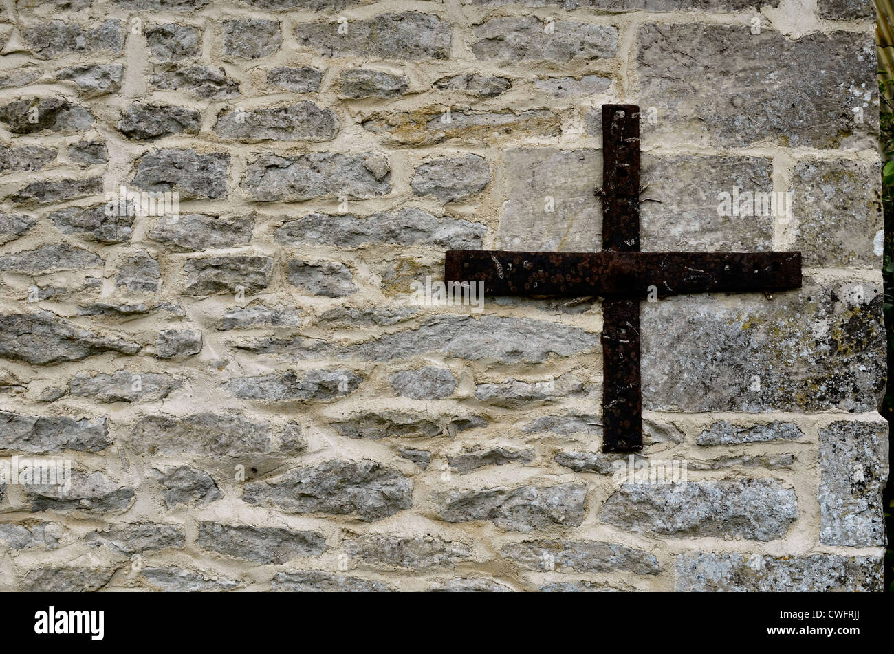 Denial of access, security. Stone building wall / detail of weathered stonework with reinforcing strapping - western Wiltshire Stock Photo