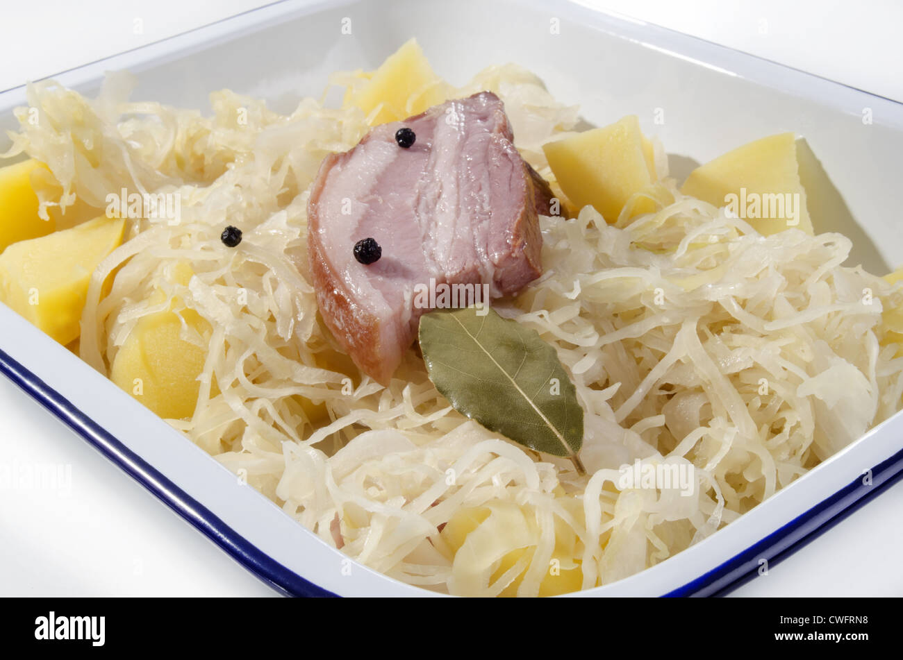 Steamed sauerkraut with pork boiled potatoes and bay leaf Stock Photo