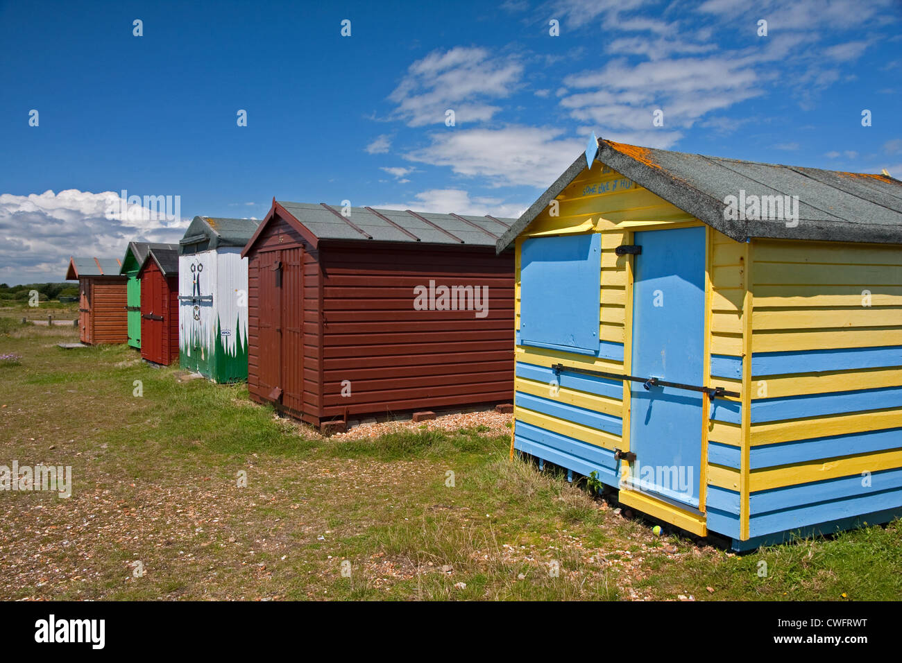 Colourful beach huts on beach at Hayling Island Stock Photo