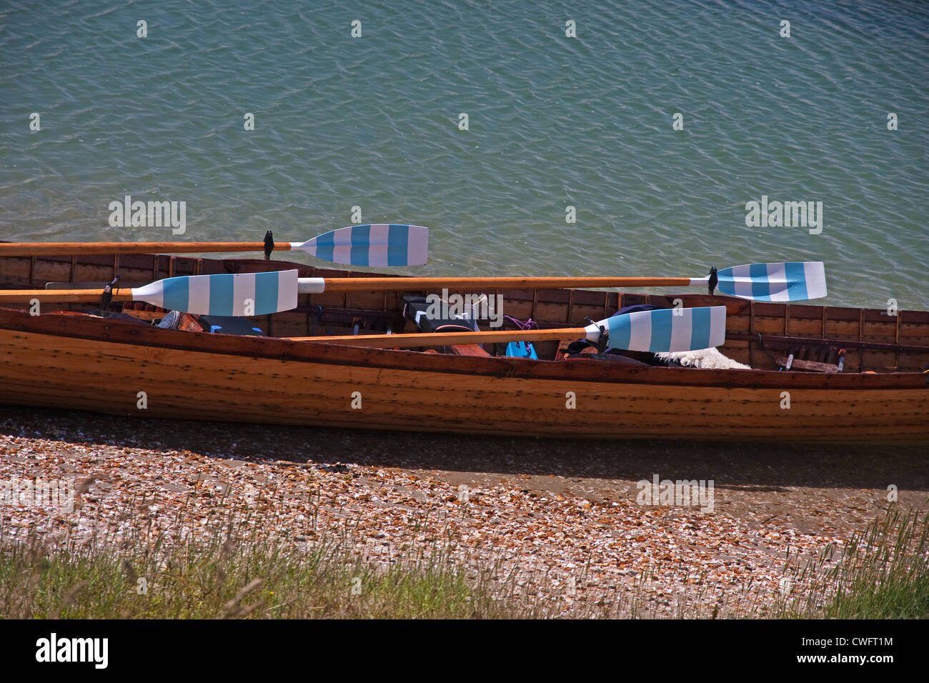 Rowing gig with striped oars Stock Photo