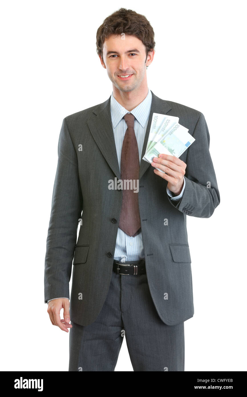 Smiling businessman showing packs of euros Stock Photo - Alamy