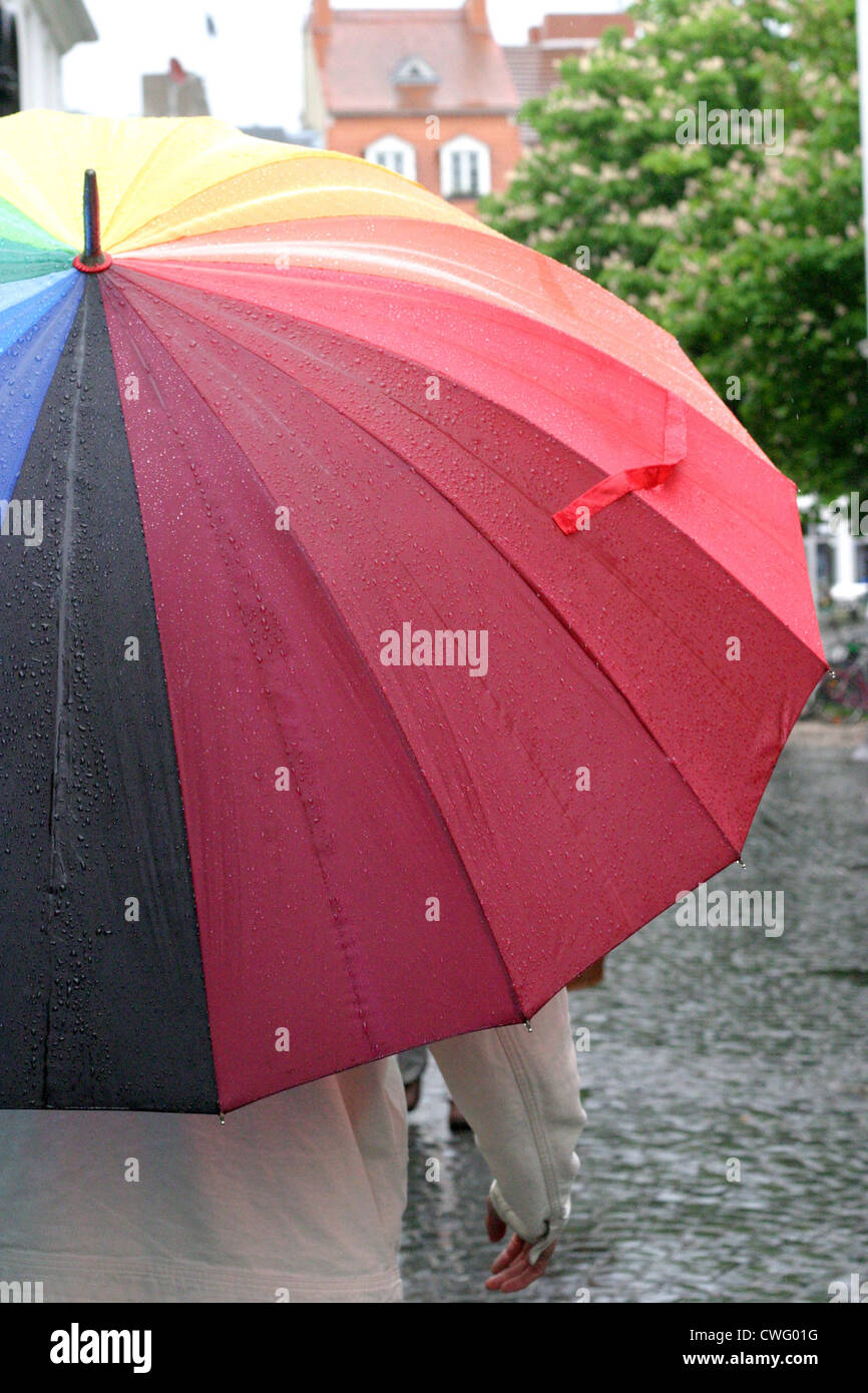 Man with colorful umbrella in a pedestrian Stock Photo - Alamy