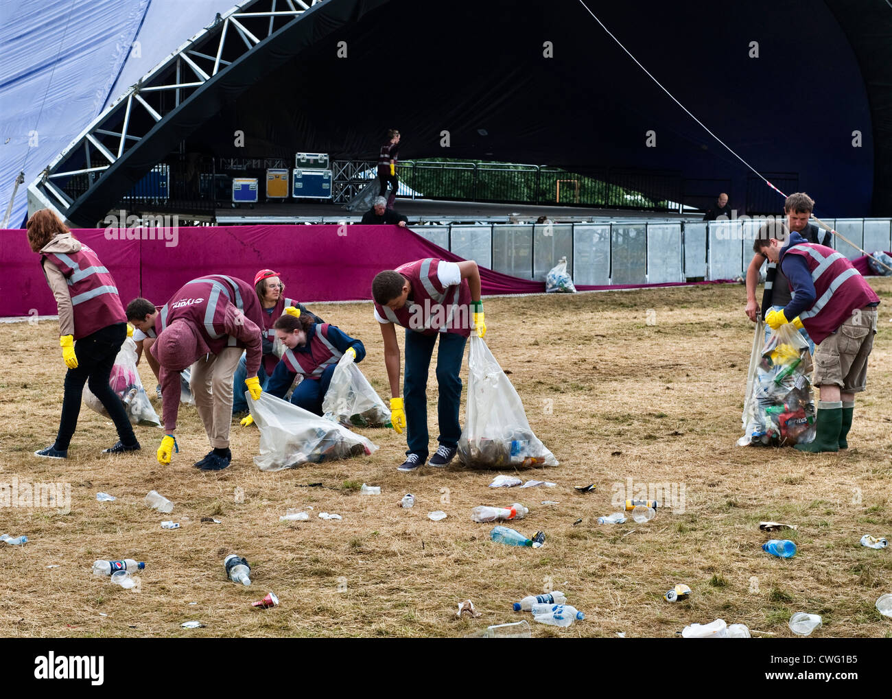 A team of litter pickers clearing up the morning after a music festival - Wilderness, Cornbury, Oxfordshire, UK Stock Photo