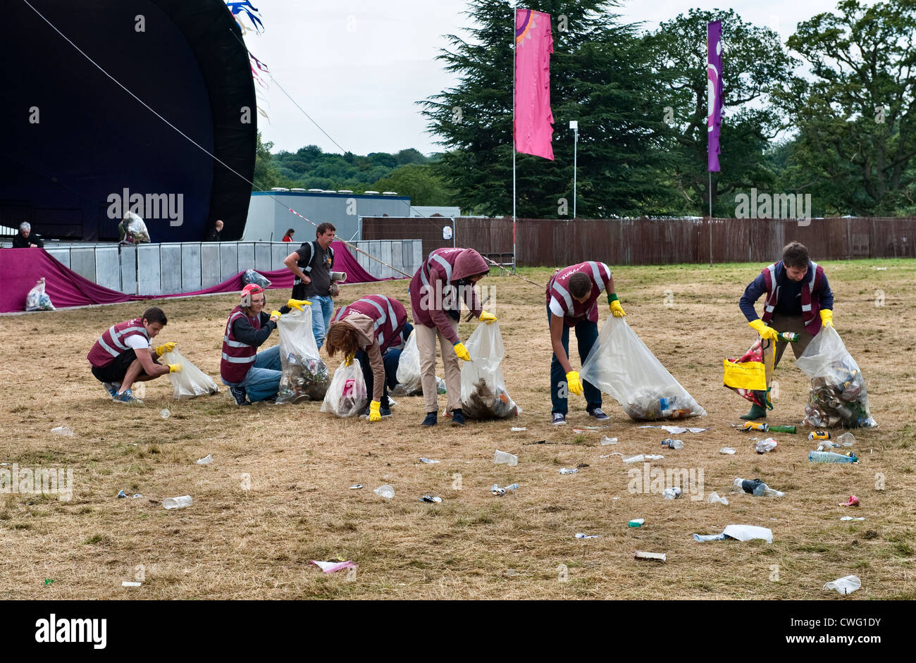 A team of litter pickers clearing up the morning after a music festival - Wilderness, Cornbury, Oxfordshire, UK Stock Photo