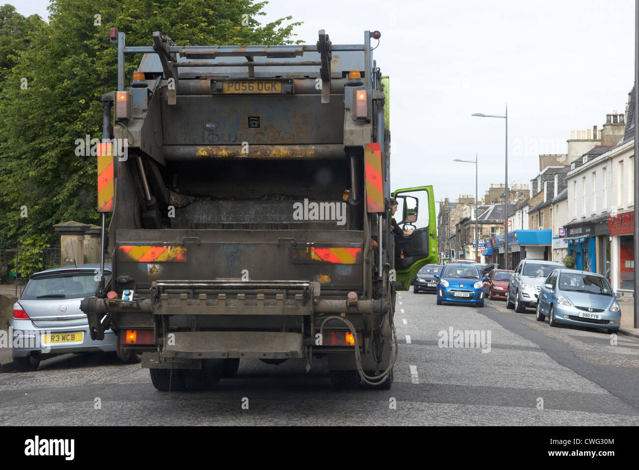 private company bin lorry double parked in the middle of the street in edinburgh, scotland, uk, united kingdom Stock Photo