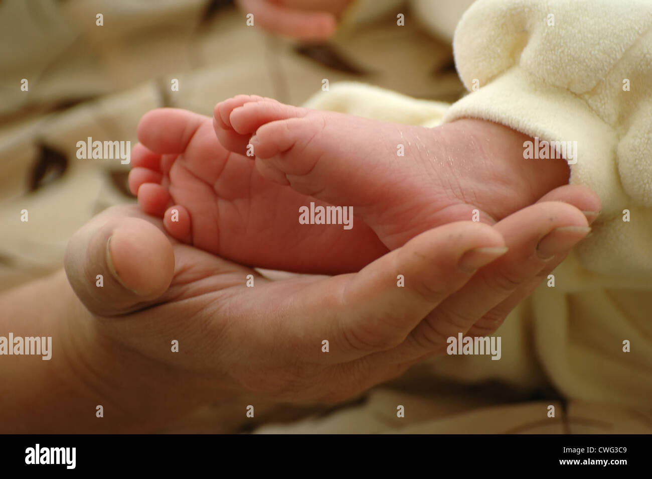 Mother holding her newborn feet Stock Photo