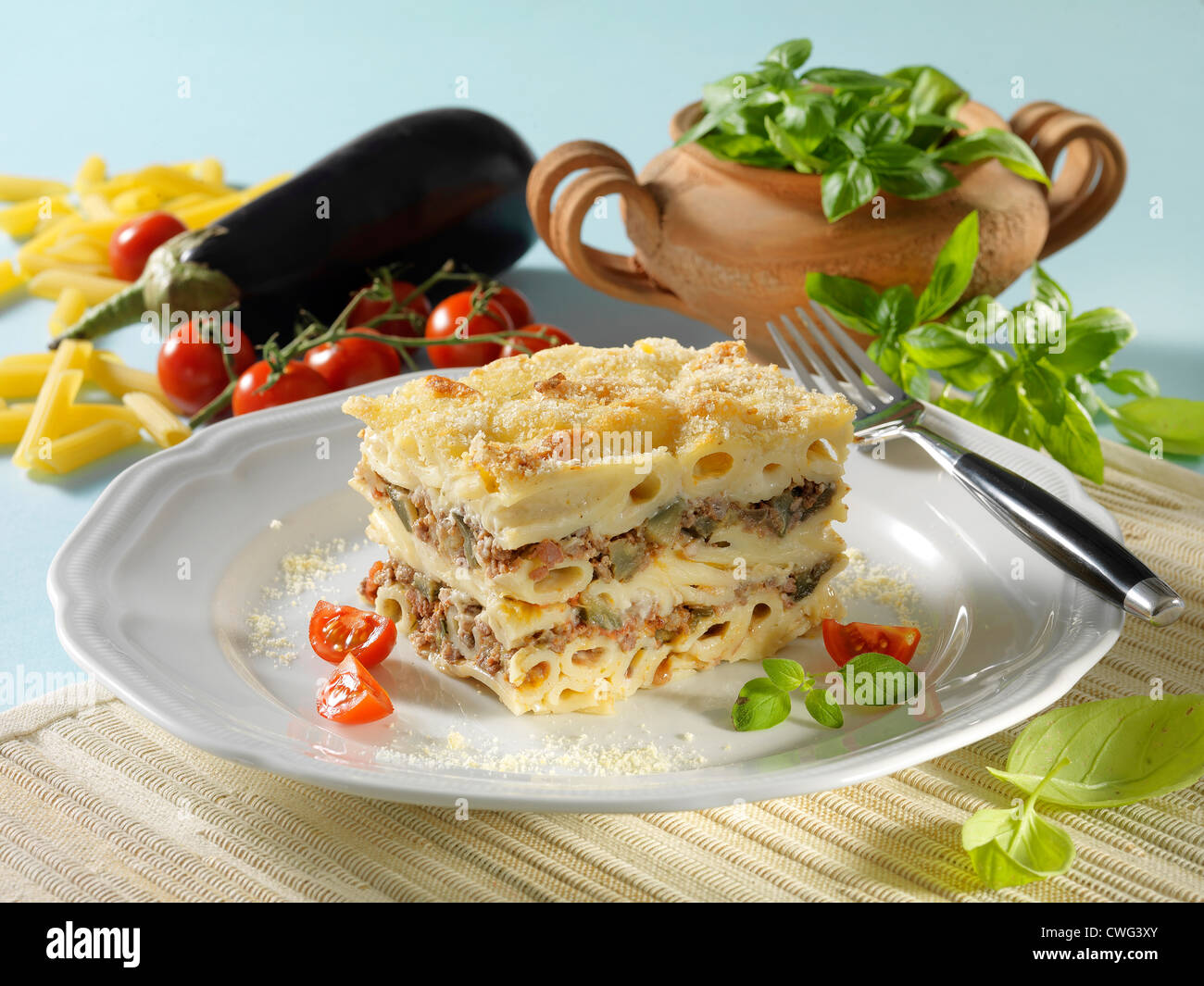 Greek piled pasta on white plate Stock Photo