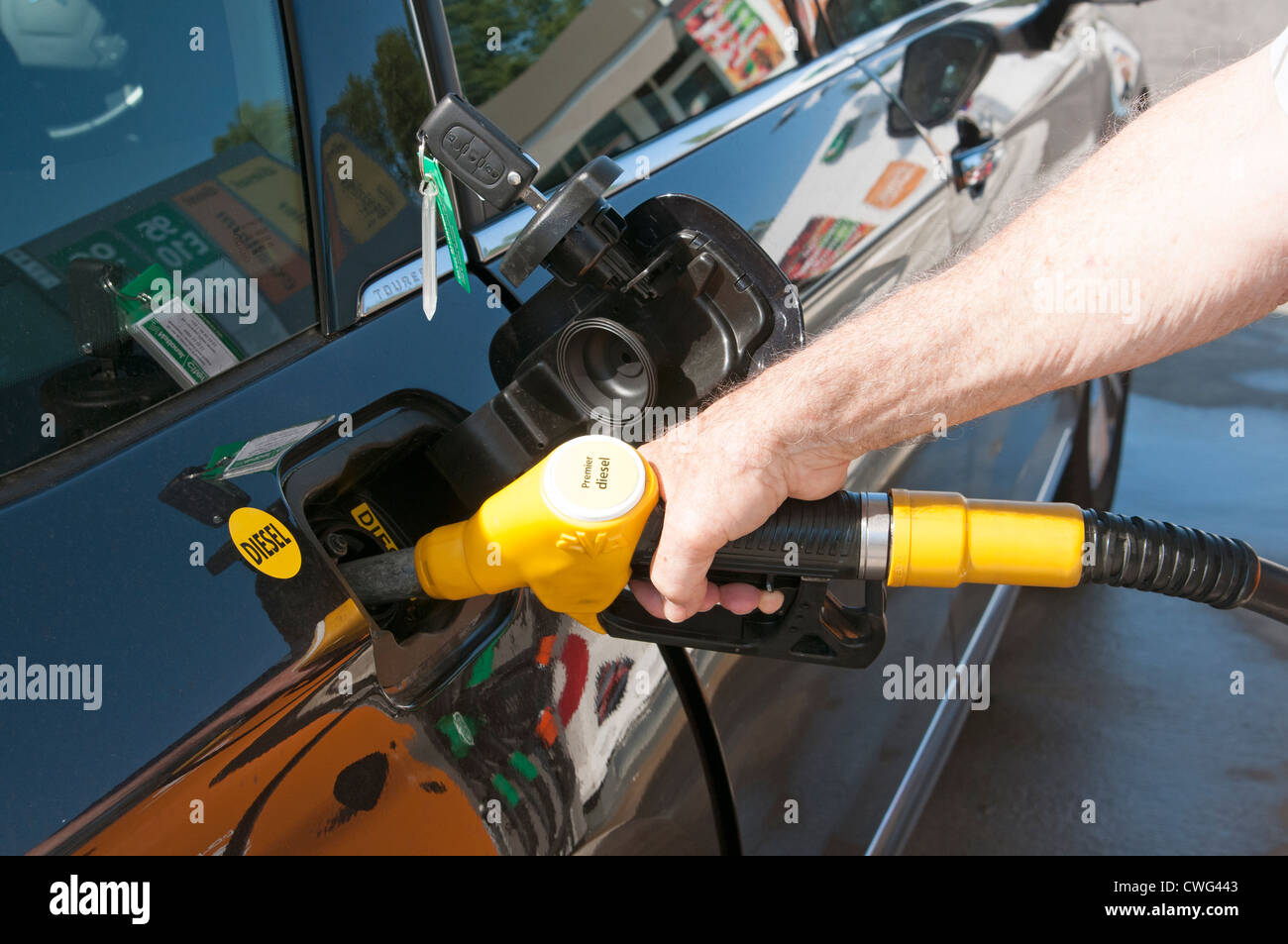 Filling the diesel fuel tank of a Citroen car at a service station Stock Photo