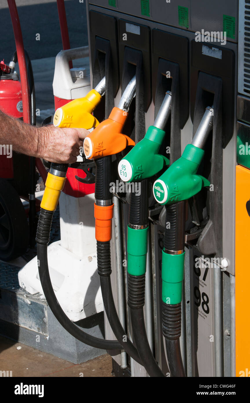 Selecting by colour fuel pump at a self service petrol station Stock Photo