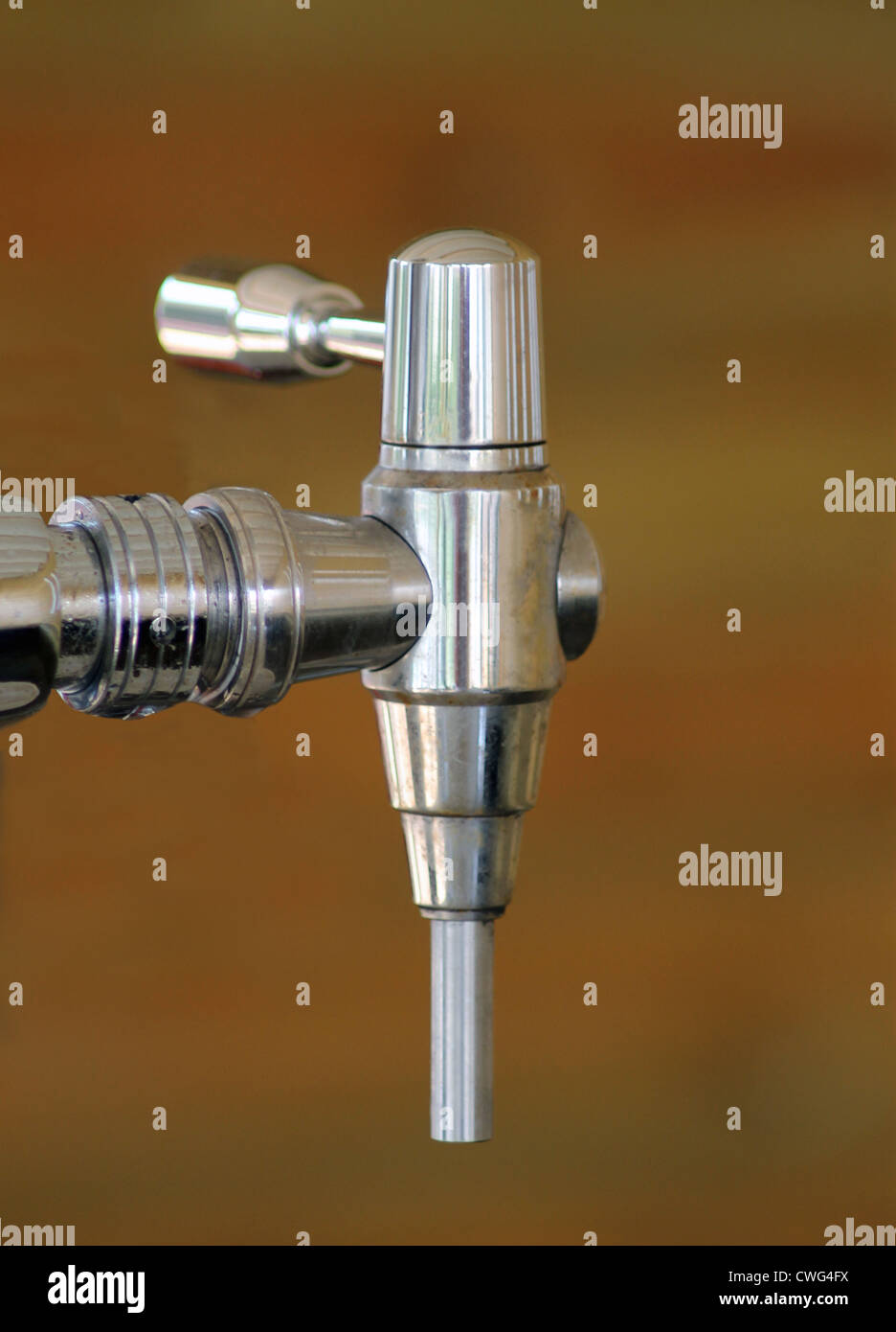 Chrome beer tap or pump on dark background. Stock Photo