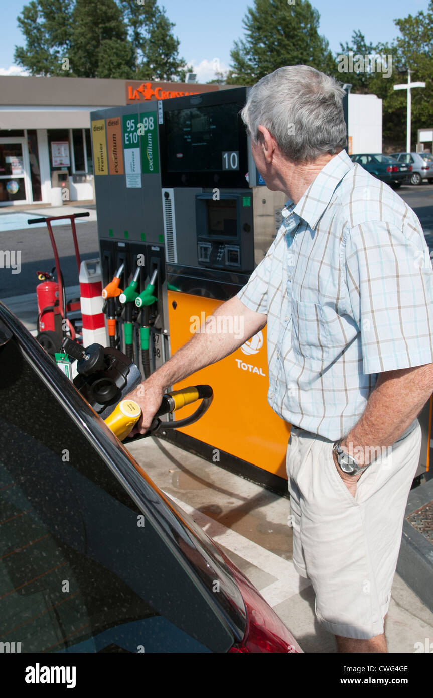 Man filling his car with fuel at a French filling station Stock Photo