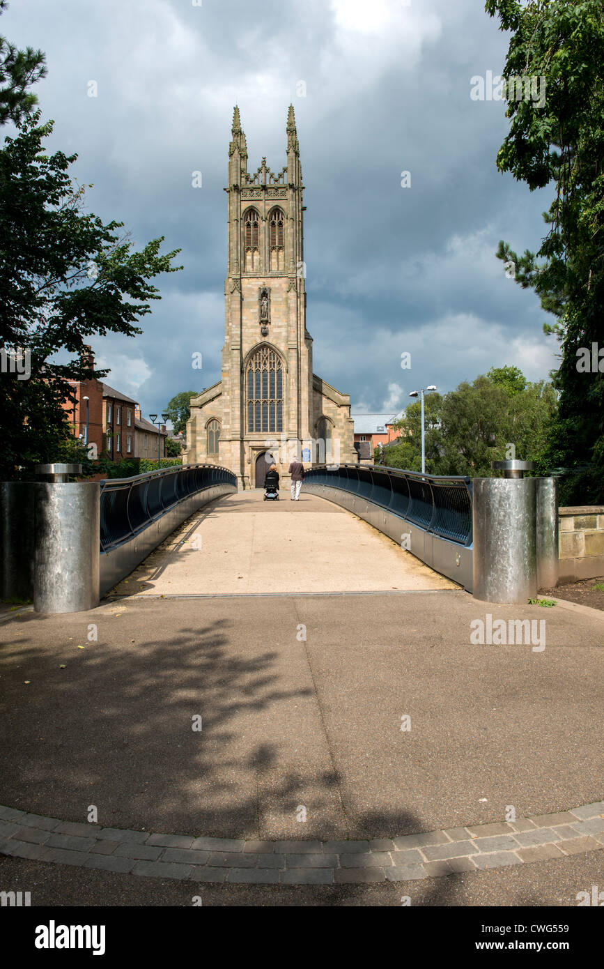 St Mary's Church Derby a pedestrian and wheelchair user cross the bridge from the Cathedral Quarter Stock Photo