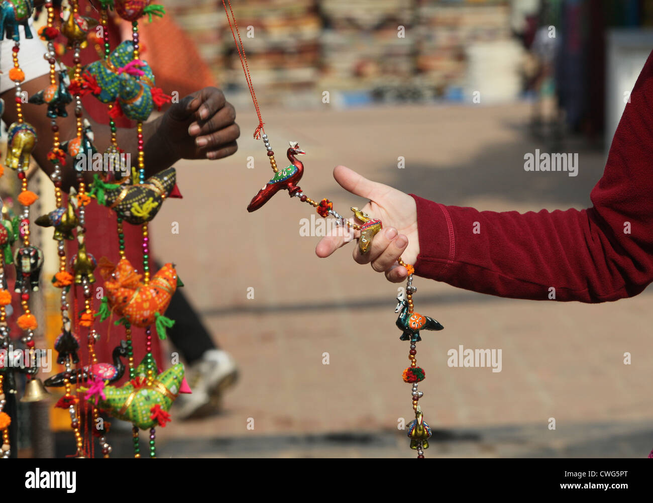a buyer cheching decorated door beads in a handicraft fair Stock Photo