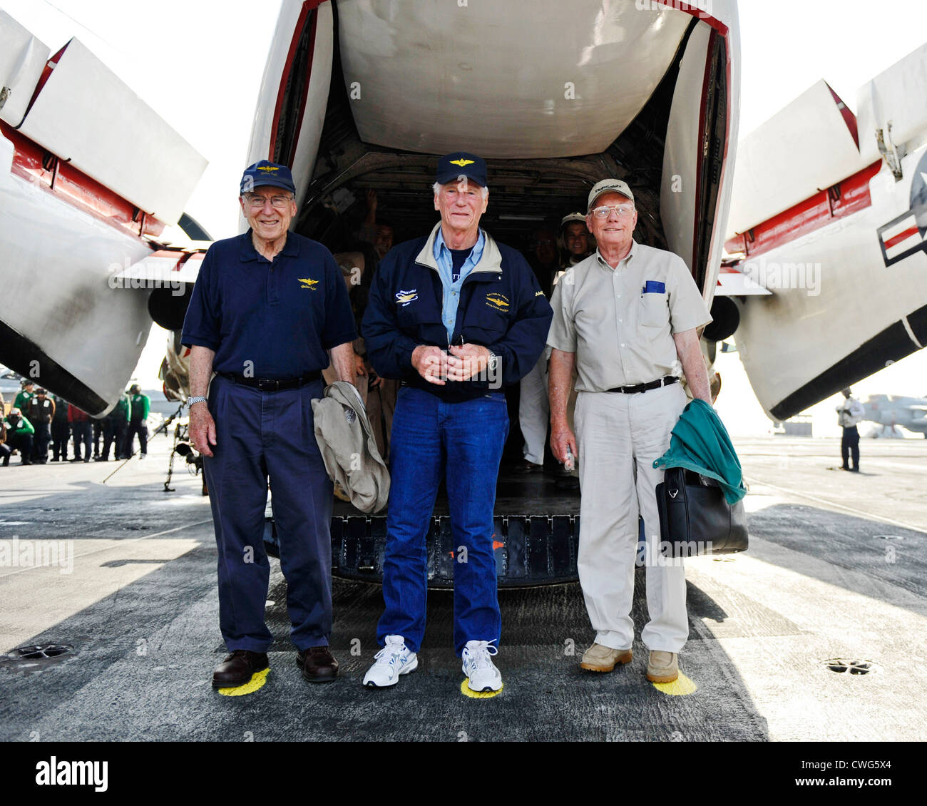 Retired astronauts Capt. Jim Lovell, Capt. Gene Cernan, and Neil Armstrong stand on painted footprints to commemorate their Legends of Aerospace tour aboard the aircraft carrier USS Harry S. Truman. The astronauts visited the ship to meet with sailors and Marines. The Harry S. Truman Carrier Strike Group is deployed in support of maritime security operations and theater security cooperation efforts in the U.S. 5th Fleet area of responsibility. Stock Photo