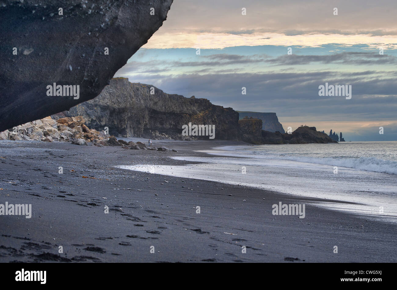 A long black sand beach near Dyrhólaey in South Iceland with interesting rock formations Stock Photo
