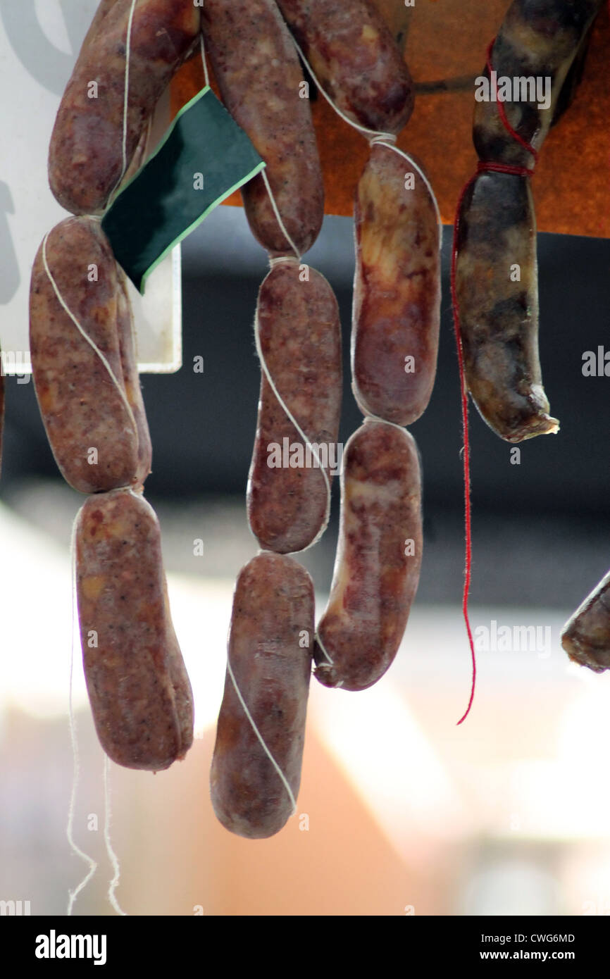 Salami sausages hung from a market stall in Spain. Stock Photo