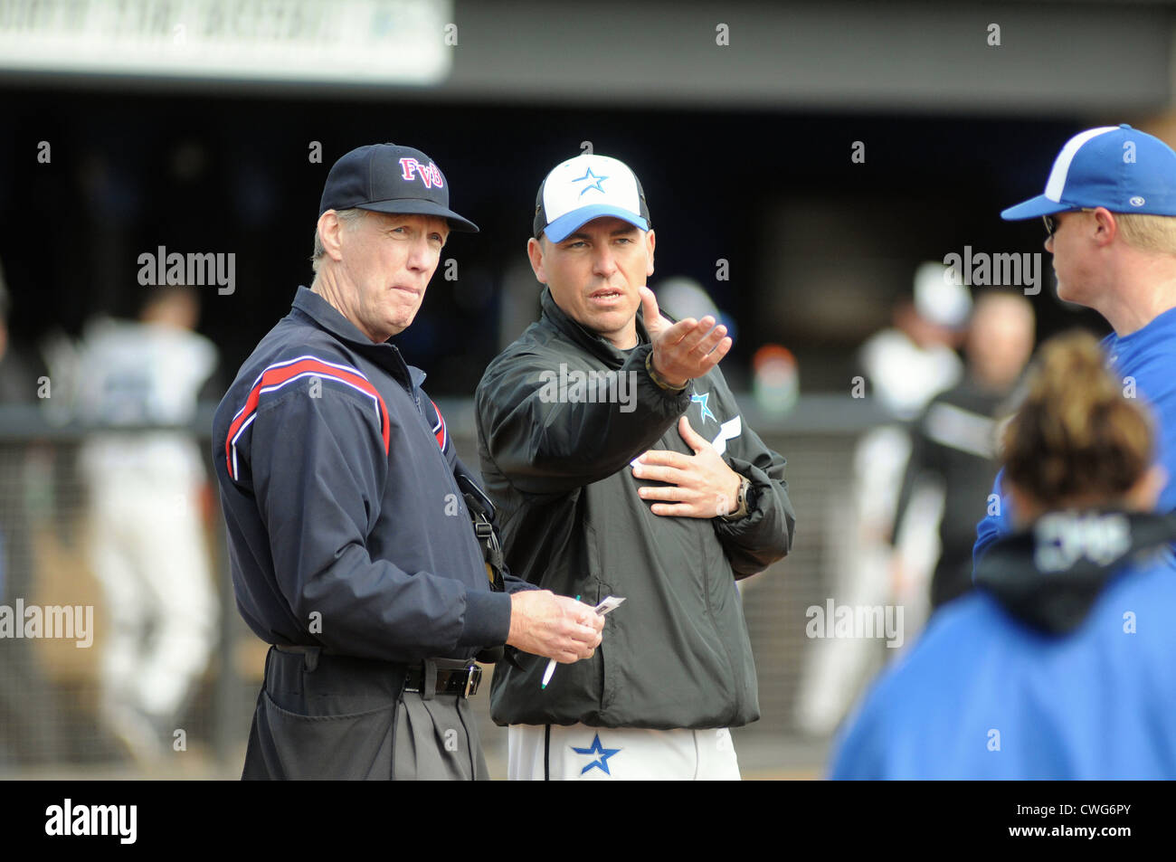 Baseball Coach and umpire discuss ground rules prior to the start of a high school game. USA. Stock Photo