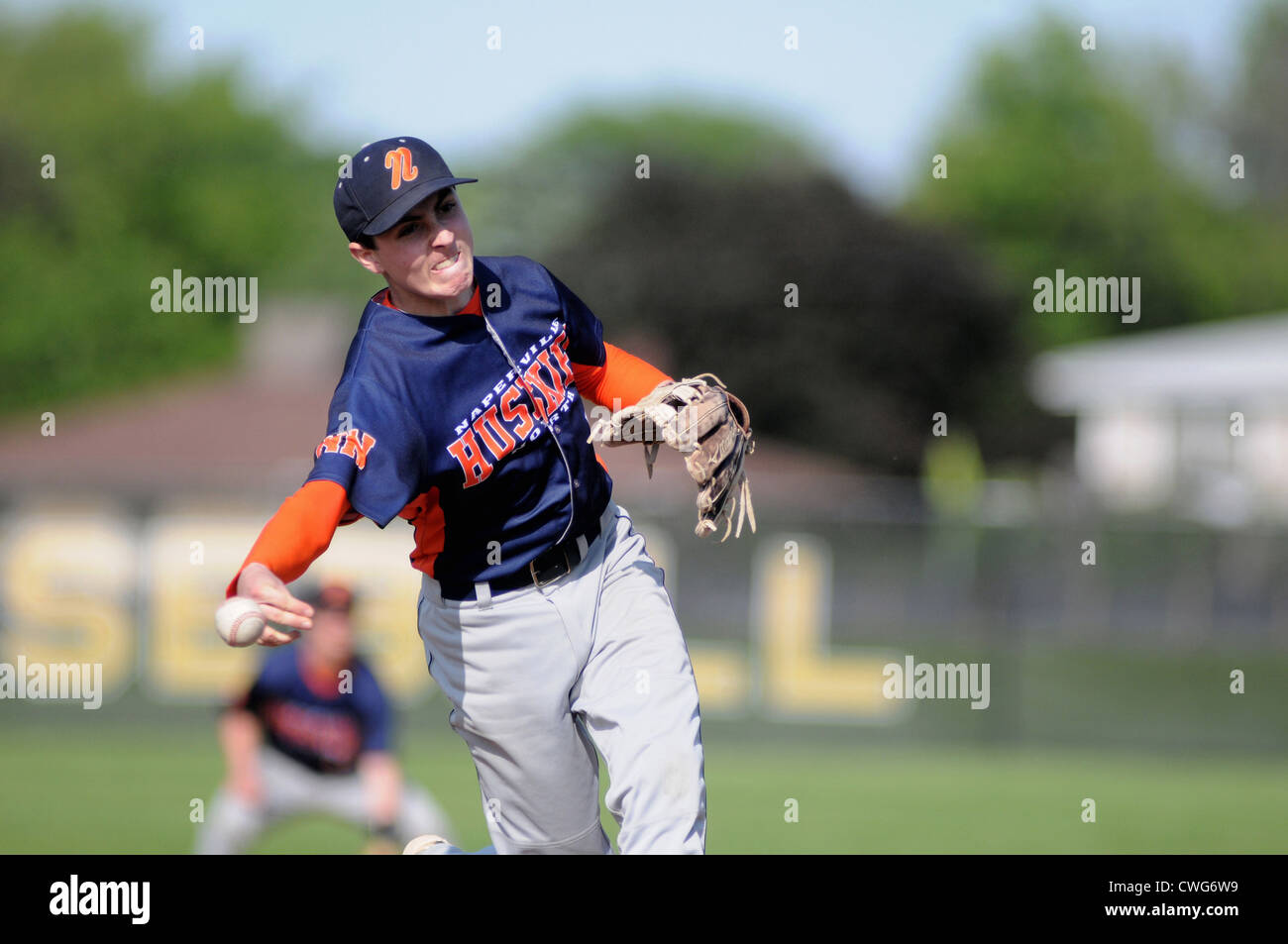 Baseball Pitcher with an unusual side arm delivery pitches during a high school game. USA. Stock Photo