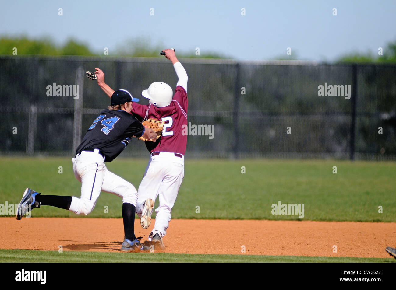 First baseman tags a base runner during a rundown play between first and second base. USA. Stock Photo