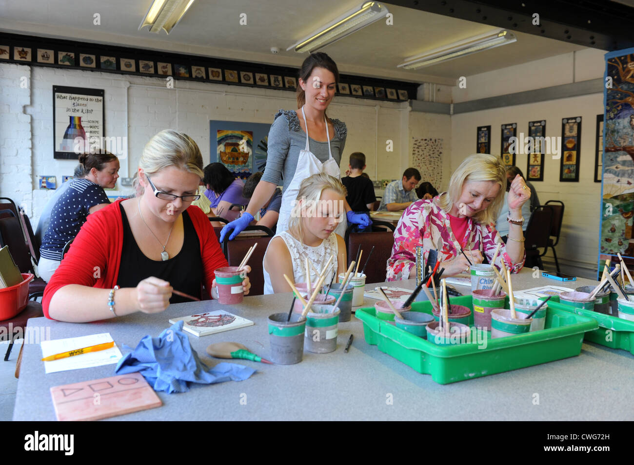 Jackfield Tile Museum Tile Decorating Workshop. Actress Lisa Goddard (right) with her daughter Sophie Jewry and grand daughter. Stock Photo