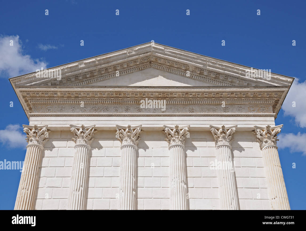 Detail of Maison Carree Roman Temple known as the Square House showing the Tympanum and Corinthian Capitals in Nimes France Stock Photo