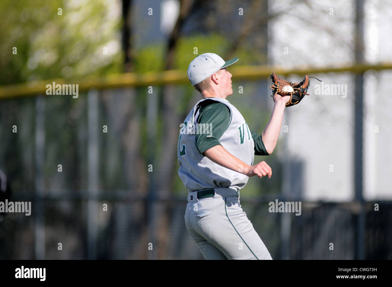 Baseball Player catches a pop fly high school game. USA. Stock Photo