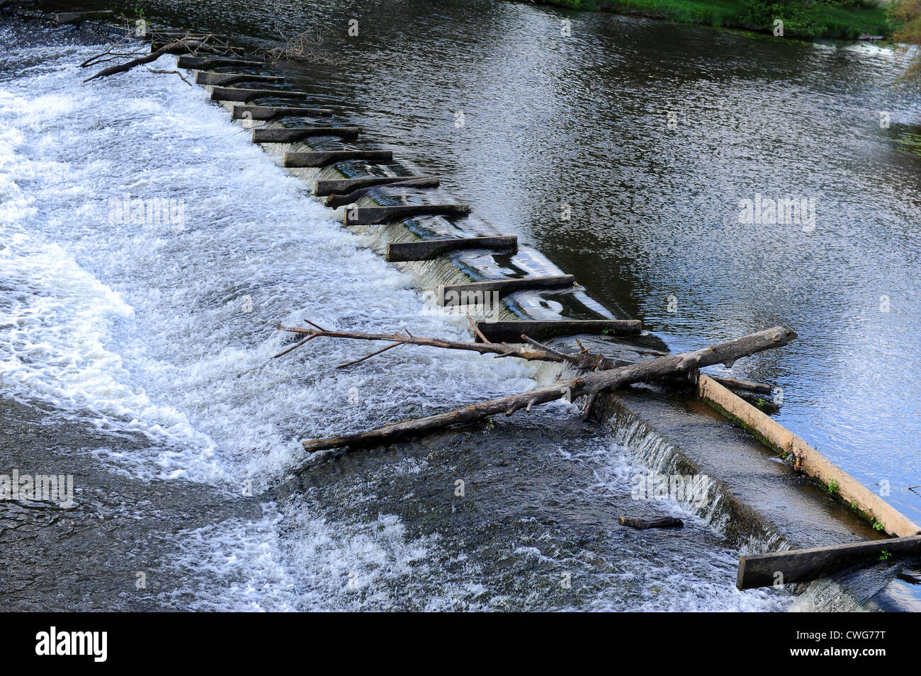 Logs floating over weirMalestroit in the Morbihan department of Brittany in north-western France Stock Photo