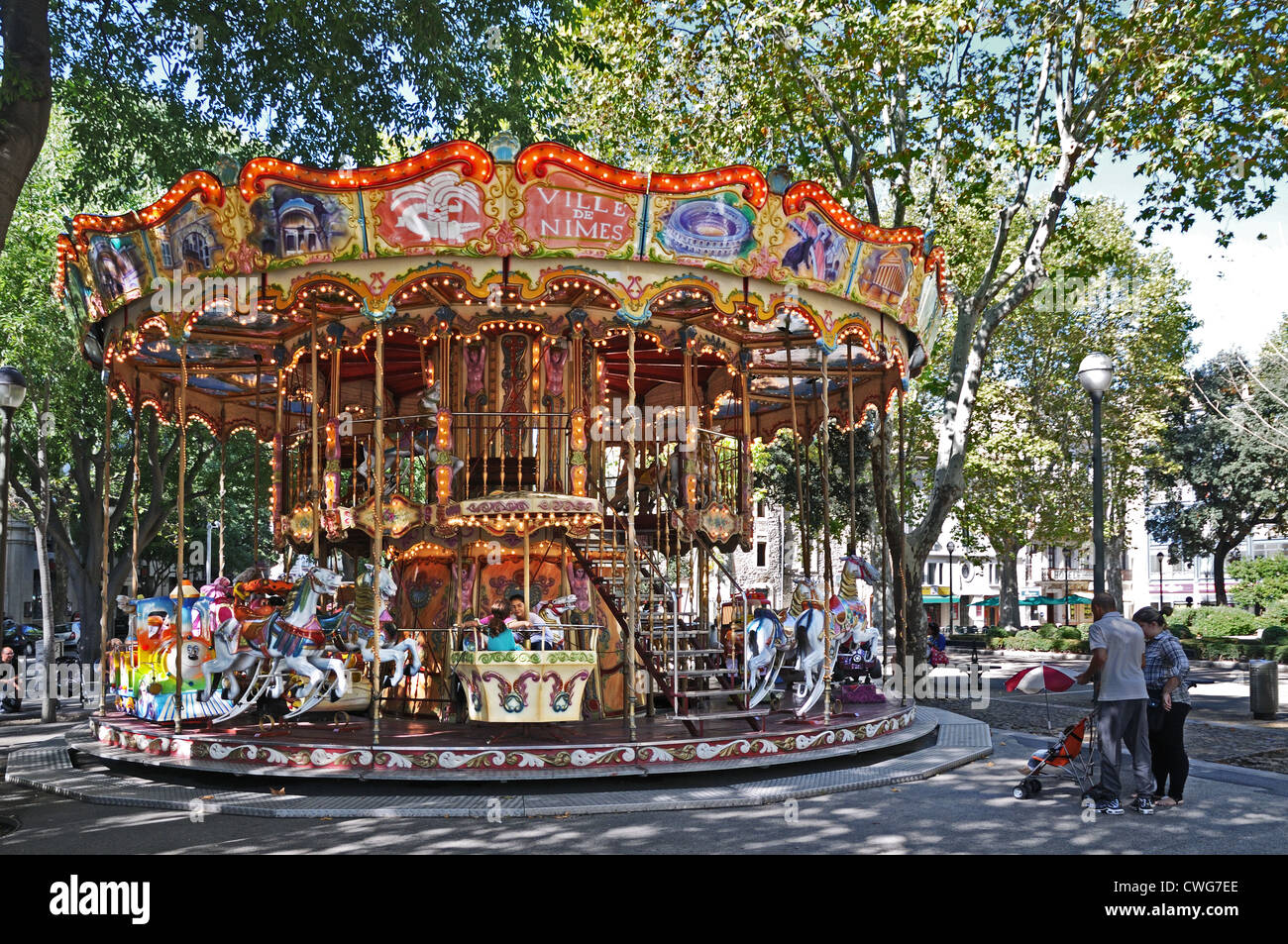 Childrens Carousel Carrousel merry-go-round Roundabout VILLE DE NIMES with flying horses Nîmes France Stock Photo