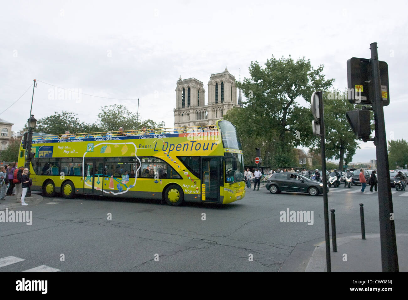 Open double decker tourist bus in front of Notre Dame cathedral in