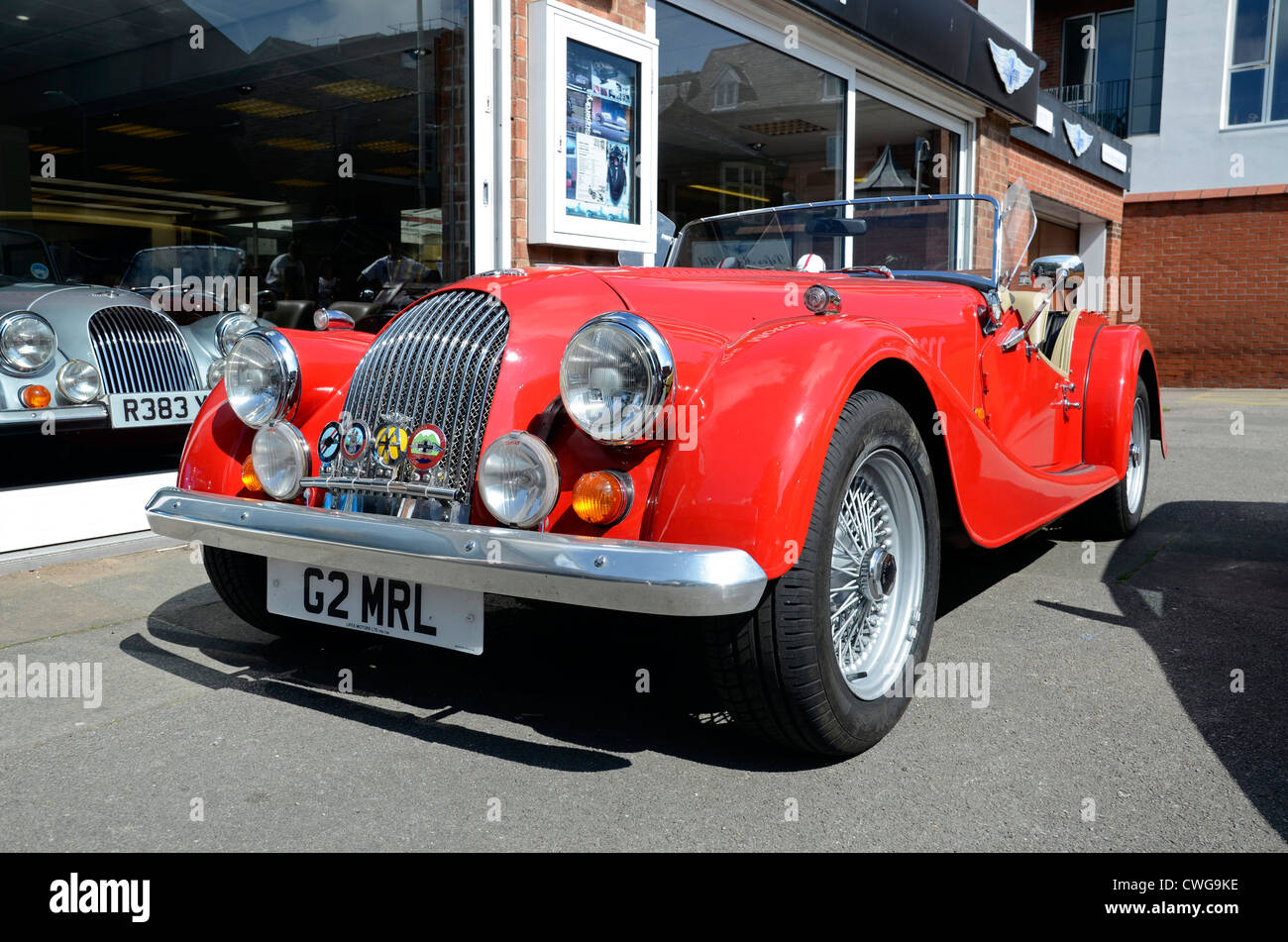 A red sports car, parked outside a motor dealers in Southport