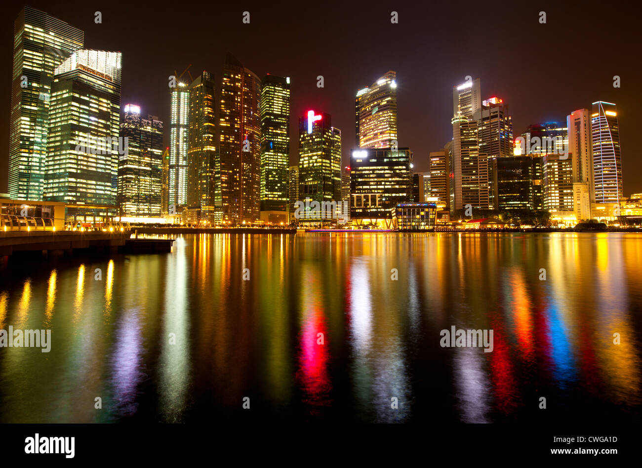 A view of Singapore business district in the night time with water reflections. Stock Photo
