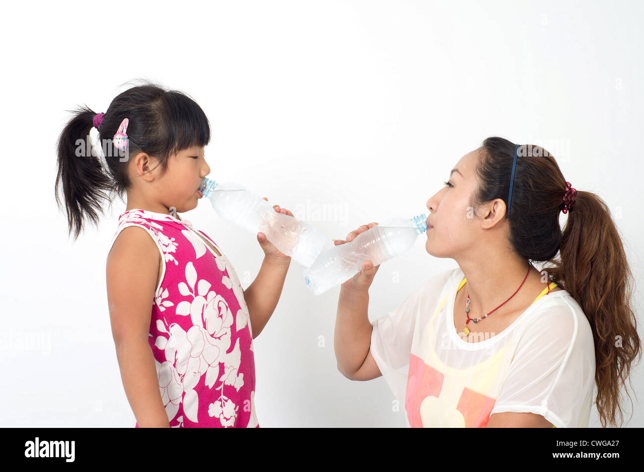 Mother daughter drink mineral water Stock Photo