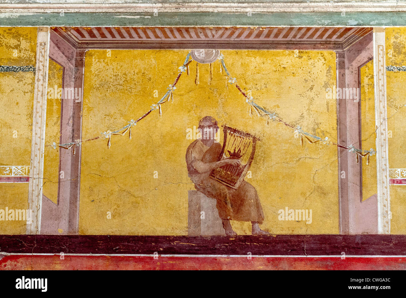 Frescos at the Villa di Poppaea at the Roman site of Oplontis, an aristocratic resort.  This shows a lyre player. Stock Photo