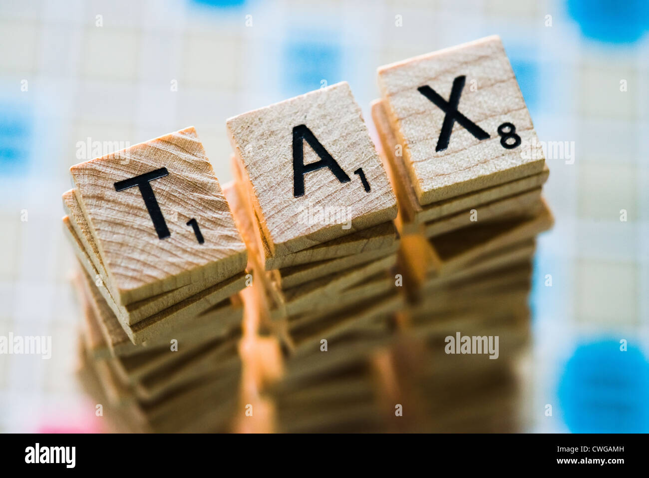 Letter tiles spelling the word TAX. Stock Photo