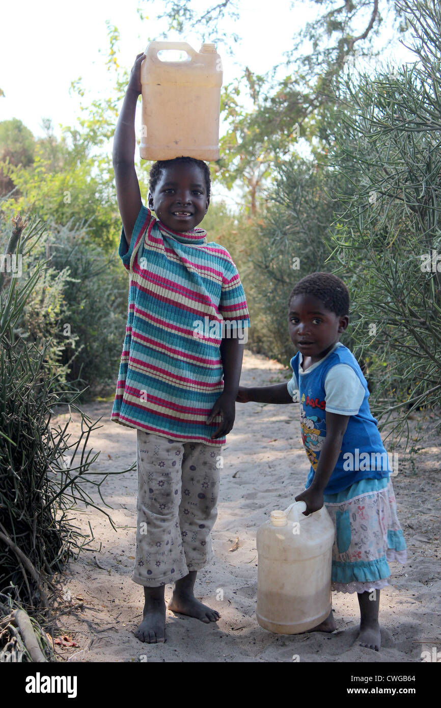 Children collecting water, Mwandi, Zambia near Livingstone. Stock Photo