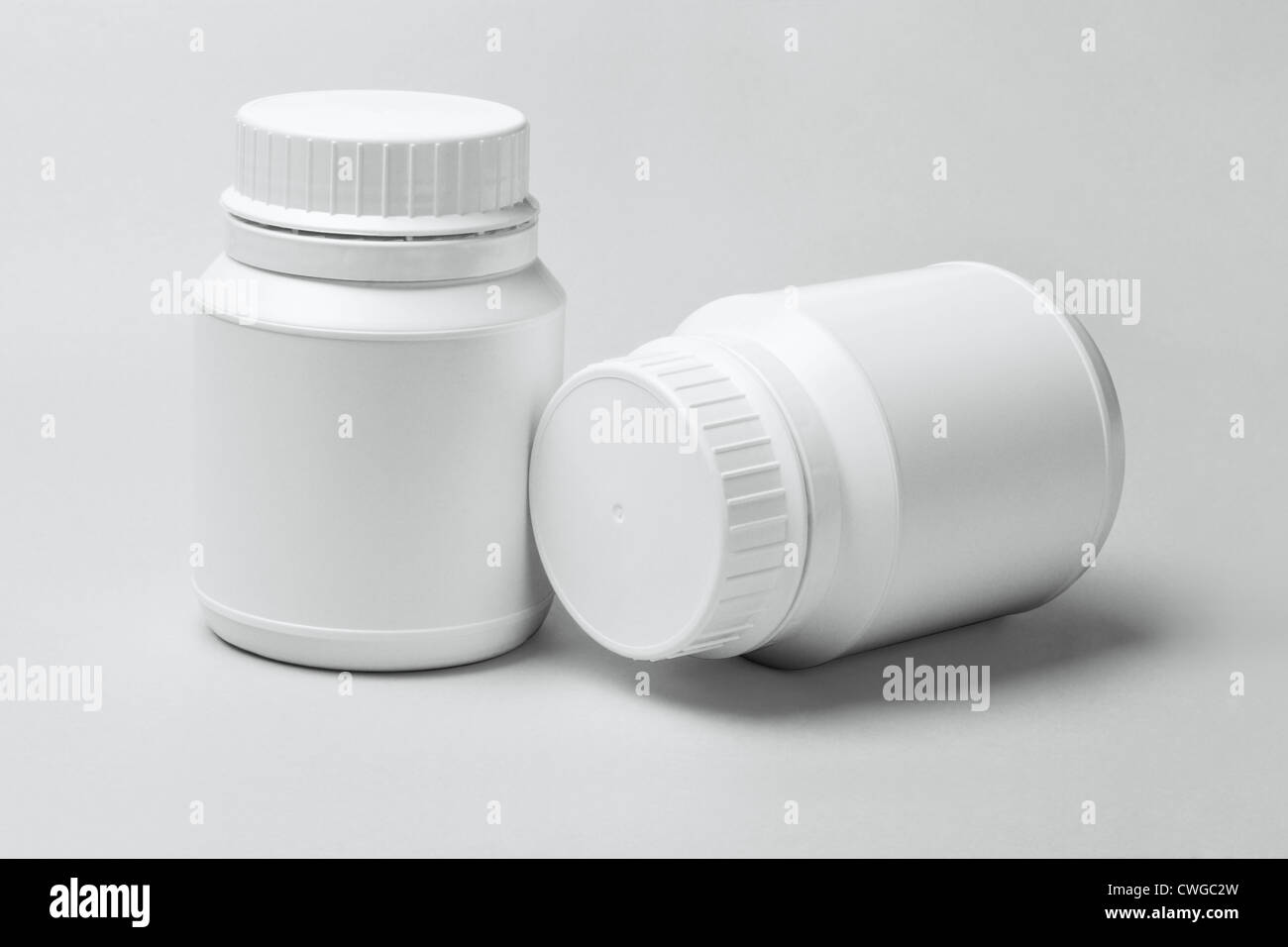 Two White Plastic Containers on Off White Background Stock Photo
