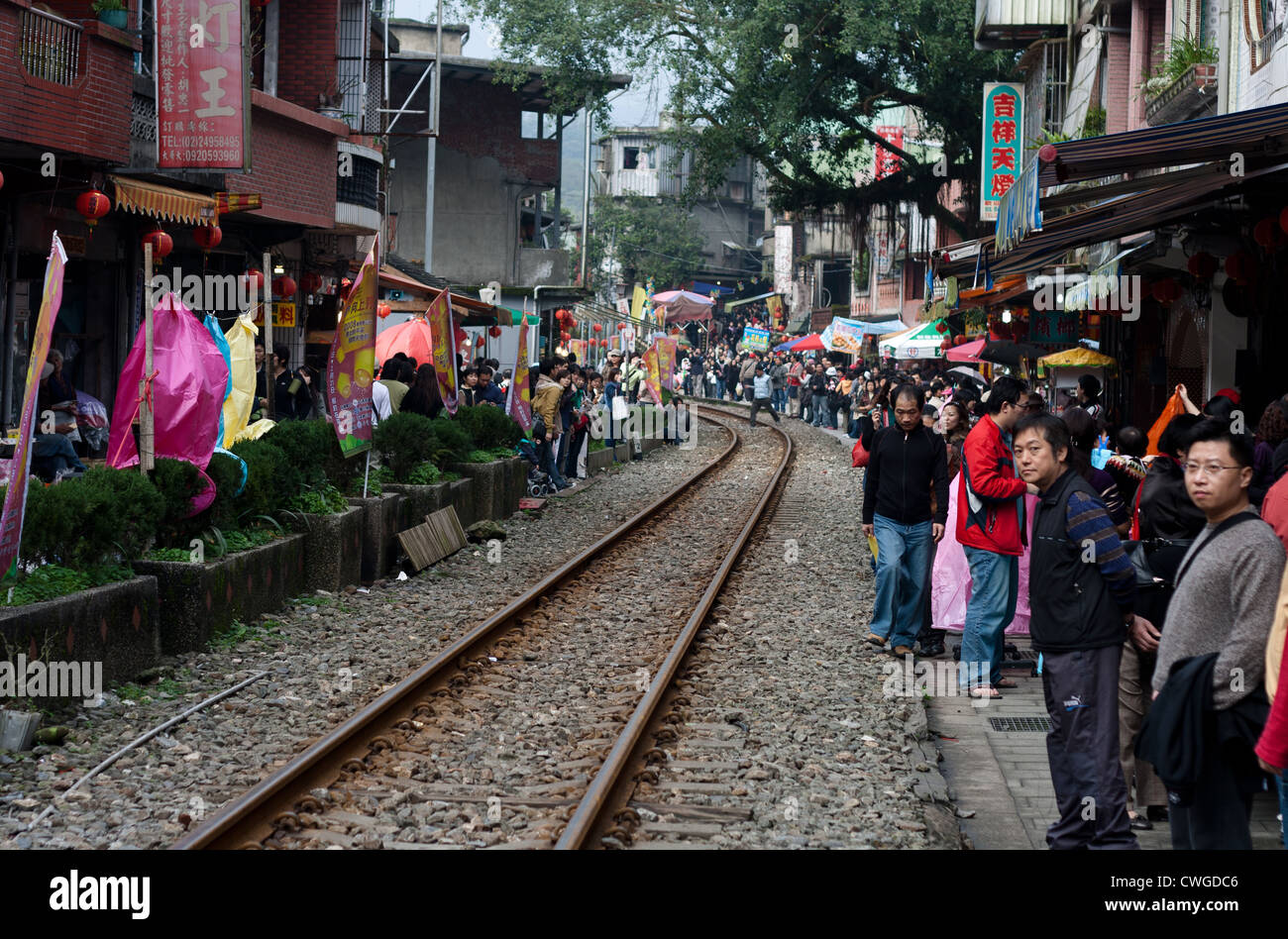 Looking down the track at the Pingxi train line during the lantern festival when crowds flock to the little town, Taiwan. Stock Photo