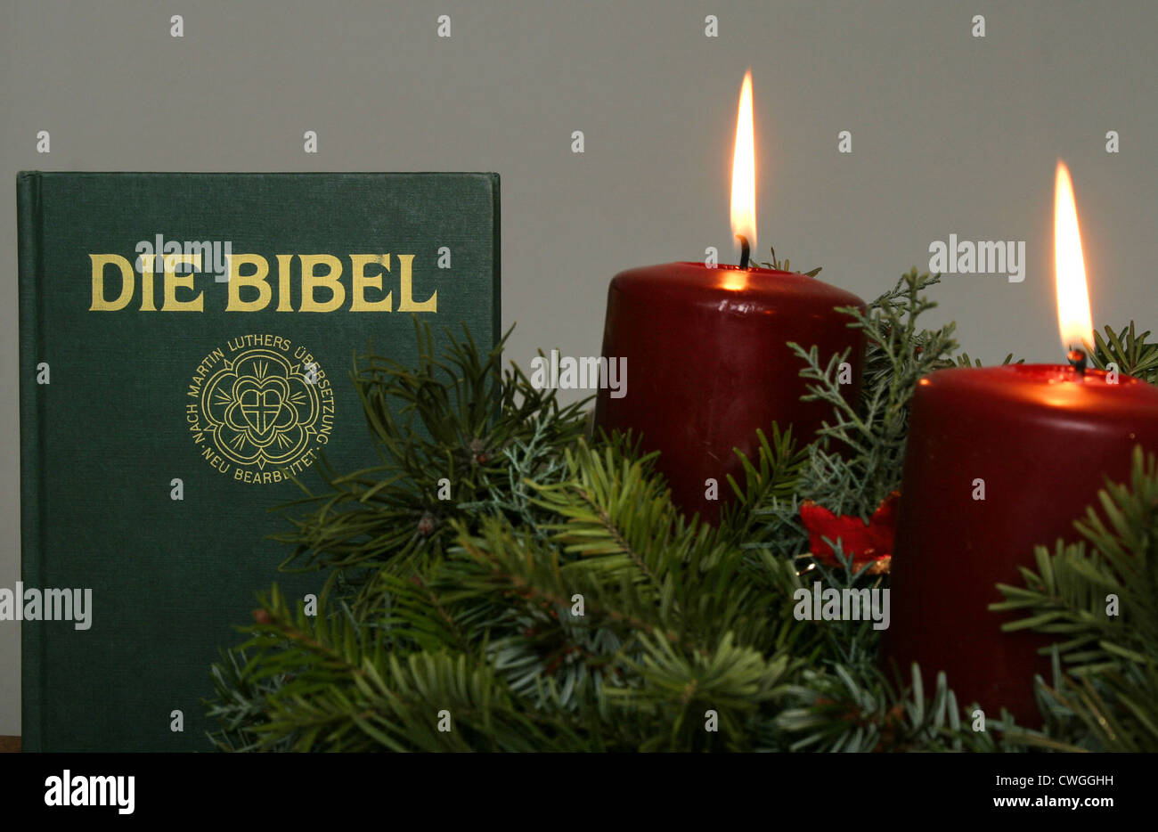 The Bible with burning candles Stock Photo Alamy
