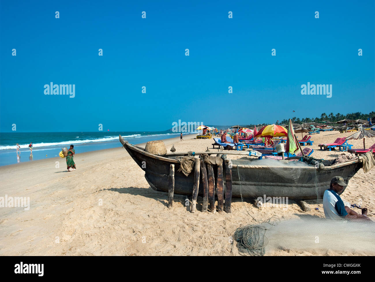 Fishing Boats and bathers on Calangute Beach, Goa, India Stock Photo