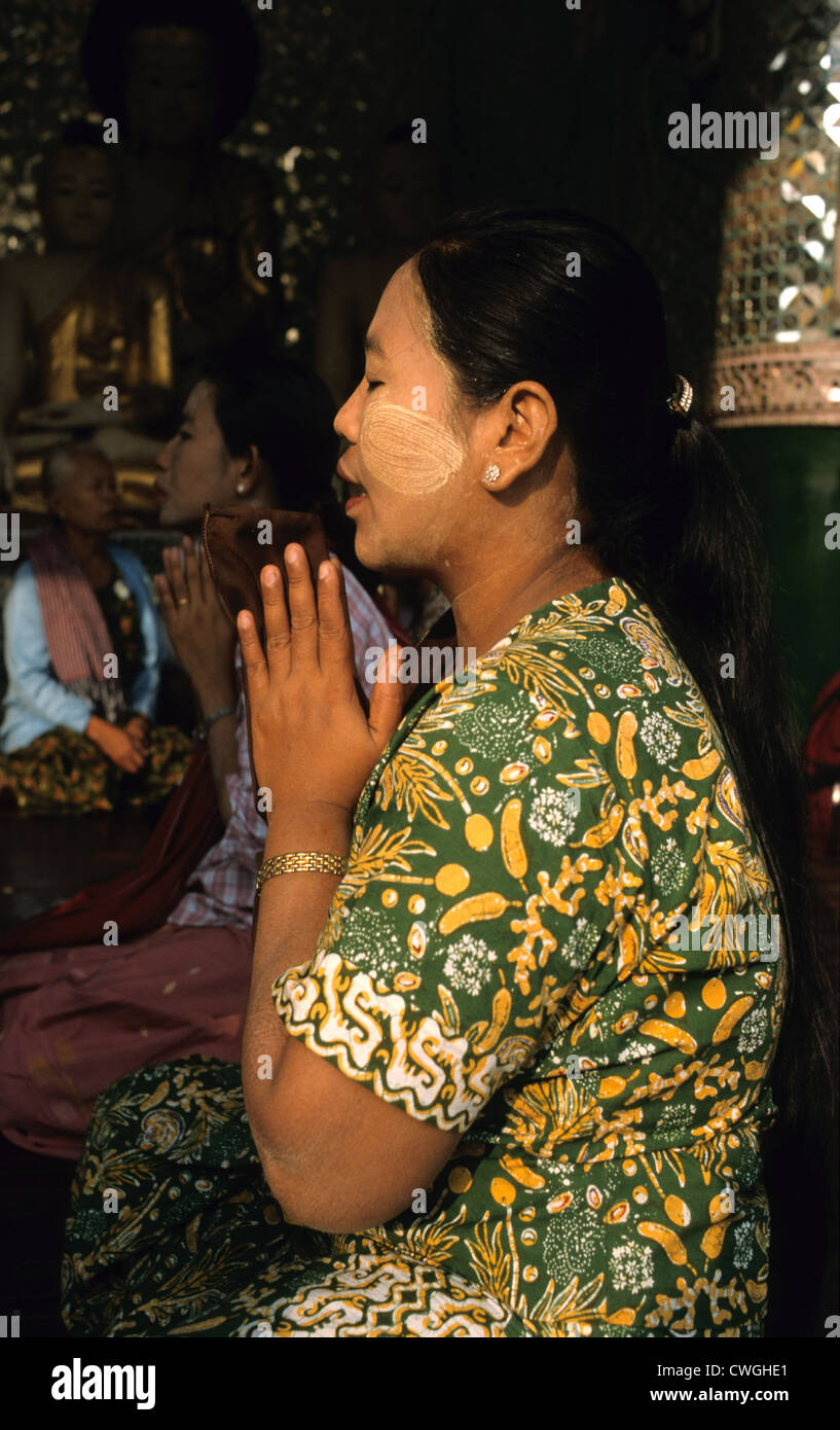 Woman praying in the Shwedagon Pagoda Stock Photo