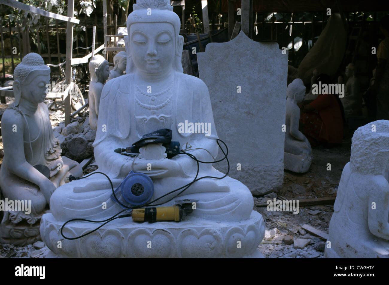 Not of finished marble Buddha tool in lap Stock Photo