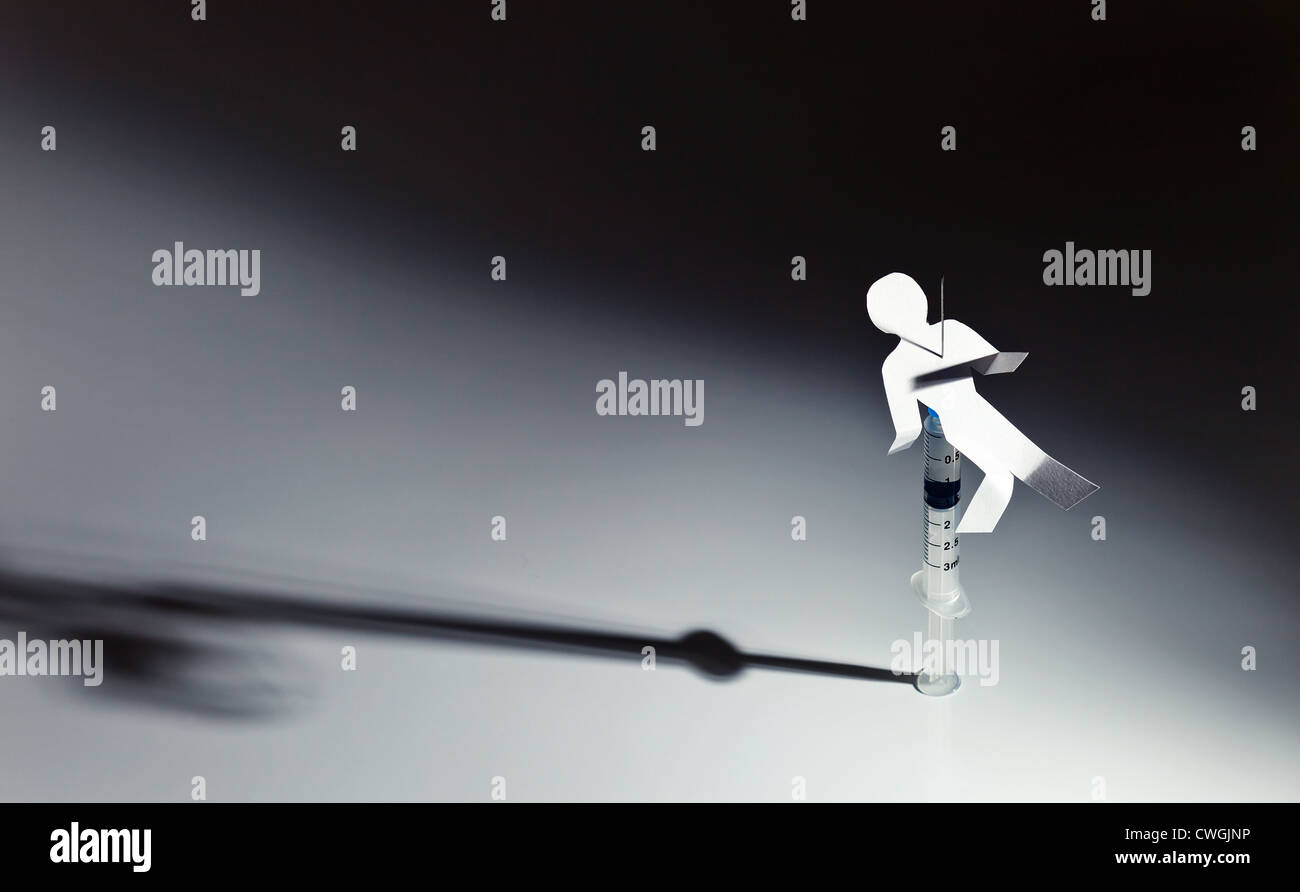 The conceptual image on a theme of narcotic dependence, a white reflective background. Stock Photo